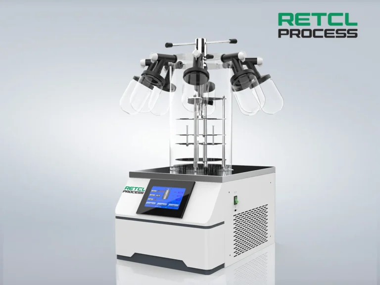 A Benchtop Freeze Dryer with several clear drying flasks attached to manifold, featuring a digital control panel and the 'RETCI PROCESS' branding on the front, set against a plain grey background.