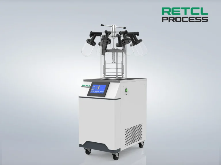 A benchtop freeze dryer with multiple flasks attached to the top manifold, featuring a digital display and housed in a compact, wheeled unit.