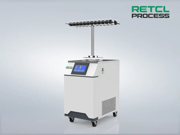 A benchtop freeze dryer with digital display, mounted on wheels, against a plain grey background, featuring a logo "RETCL PROCESS" on its side.