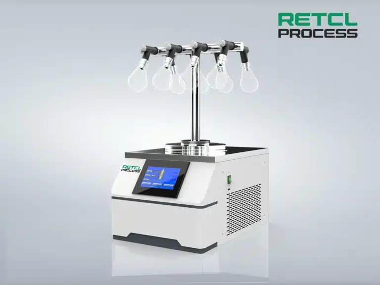 A modern Benchtop Freeze Dryer by RETCL Process with a digital interface, multiple drying flasks attached on top, set against a clear, grey background.