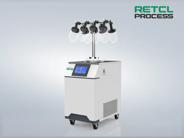 A benchtop freeze dryer with multiple manifold attachments and a digital control panel, displayed on a simple gray background.